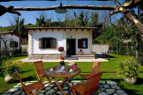 a table and chairs in front of a house at Hotel O Sole Mio in SantʼAgata sui Due Golfi