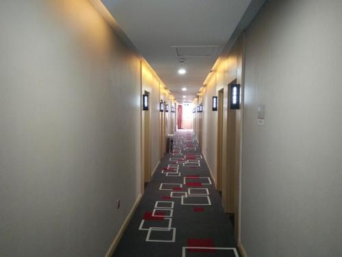 a hallway with a long row of stalls in a building at Thank Inn Chain Hotel Shandong Dezhou Decheng District Wanda Plaza in Dezhou