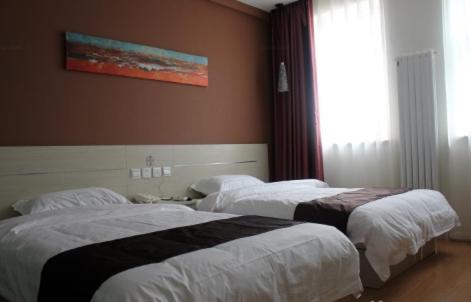 a hotel room with two beds and a window at Thank Inn Chain Hotel Hebei Cangzhou Qing County Jingfu Avenue in Qing