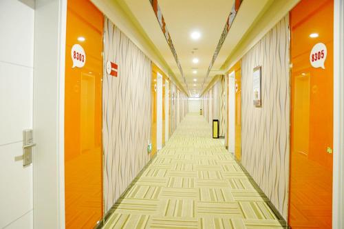a hallway of an office building with orange and white walls at Thank Inn Chain Hotel Shandong Zibo Zichuan Luzhong International Shopping mall in Zibo