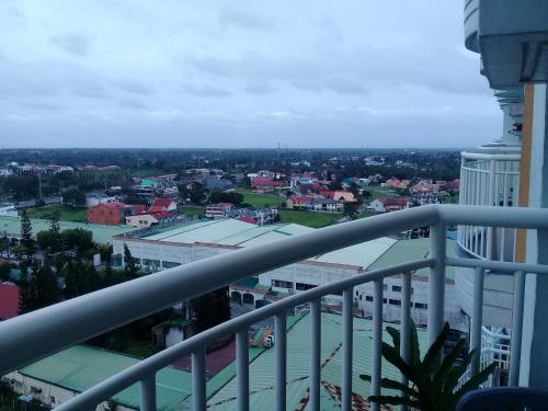 a view of a city from the balcony of a building at Miguel's Place at Tagaytay Prime Residences in Tagaytay