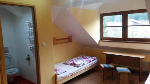 a small room with a small bed in a bathroom at Chata Ramzovské sedlo in Ramzová