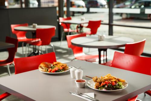 two plates of food on tables in a restaurant at ibis Hull City Centre in Hull