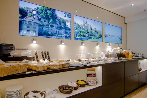 a buffet line with food on display in a restaurant at Hotel Go2Bed Weil am Rhein - Basel in Weil am Rhein