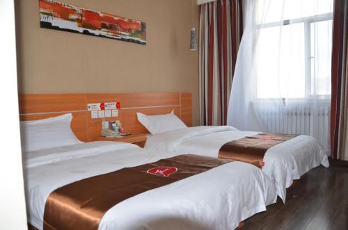 a hotel room with two beds and a window at Thank Inn Chain Hotel Gansu Jinchang Heya Road in Jinchang