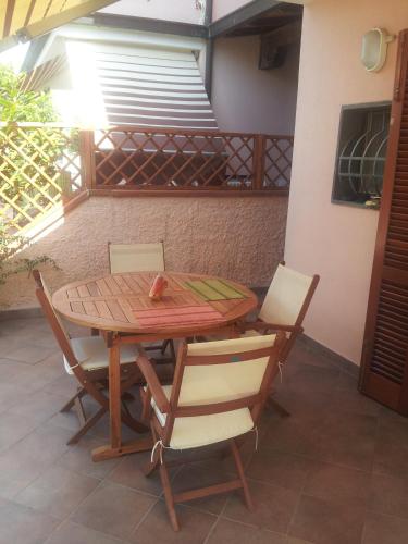 a wooden table and chairs on a patio at sole mare versilia in Cinquale