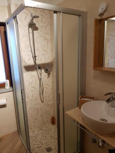 a bathroom with a shower and a sink at La Corte B&B in Candiolo