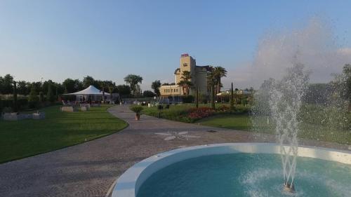 a fountain in a park with a building in the background at Hotel Ristorante Europa in Venticano