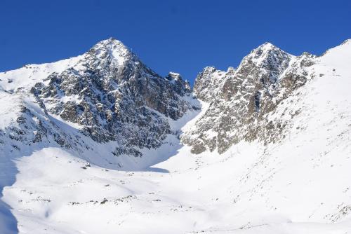 a snow covered mountain range with snow on it at Vysoké tatry - Tatranská Lomnica - zrub,drevenica in Tatranská Lomnica