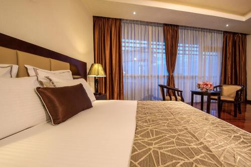 Grand Eliana Hotel Conference & Spaにあるベッド