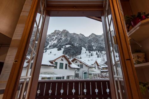 a window view of a mountain from a ski lodge at Apartmenthaus Kreuzbuche in Flühli