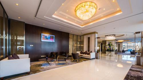 a lobby of a hotel with couches and chairs at Braira Al Wezarat in Riyadh