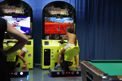 a young boy playing a video game in a arcade at La Marina Resort in La Marina