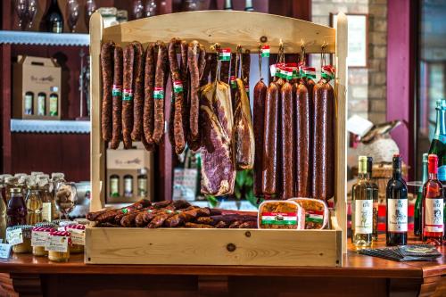 a display of meat hanging in a wooden box at Hotel Kapitany Wellness in Sümeg