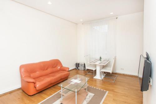 a living room with a leather chair and a table at Donelaičio 42 in Kaunas