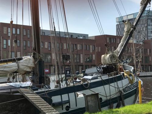 a boat is docked at a dock in the water at De Kade in Groningen