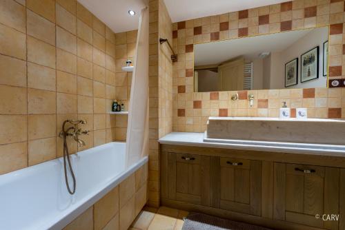 a bathroom with a tub and a sink at Kallisto Mountain House II in Arachova