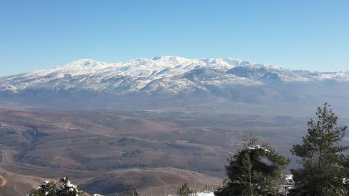 a snow covered mountain in the middle of a valley at Besof Haderech in Misgav ‘Am
