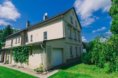 an old white house with a yard at Lusatia House in Kytlice