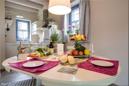 a kitchen with a table with fruits and vegetables on it at Cascina Arcangelo Raffaele in Verduno