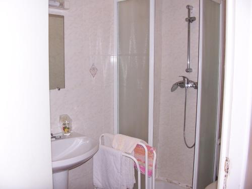 a bathroom with a shower and a sink at La Vieille Auberge in Saint-Privat-dʼAllier