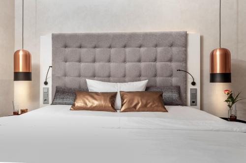 a bedroom with a large white bed with two pillows at Hotel Monika in Büttelborn