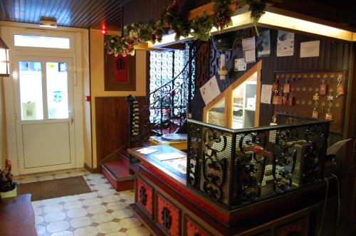 a restaurant with a counter in a room with a door at La Vieille Auberge in Saint-Privat-dʼAllier
