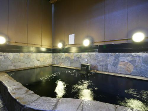 a pool of water with lights on top of it at APA Hotel Chiba Yachiyo Midorigaoka in Yachiyo