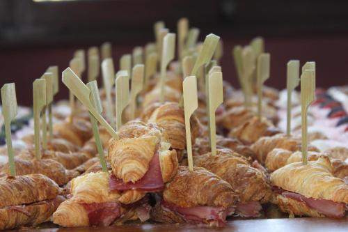 a bunch of croissants and pastries with wooden sticks in them at Villa Soleil in Colleretto Giacosa
