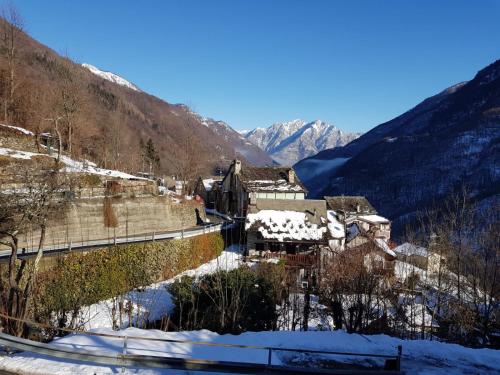 a village in the mountains in the snow at Coccinella House in Calasca Castiglione