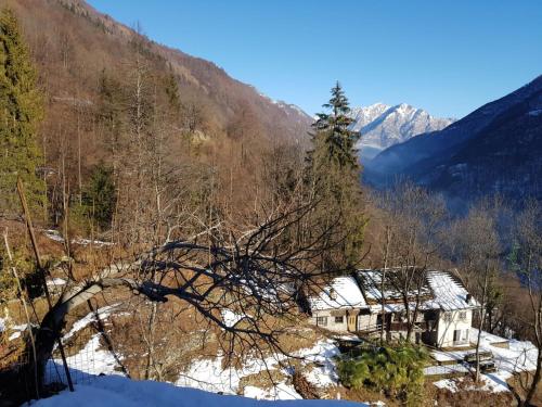 a house in the middle of a snowy mountain at Coccinella House in Calasca Castiglione