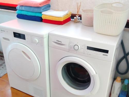 a laundry room with a washer and dryer at Farol de Vida in Coimbra