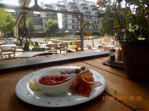 a bowl of food on a plate on a table at Apartment Sofia-Konaci in Kopaonik