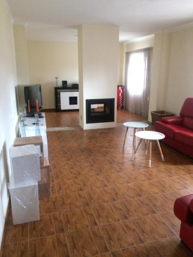 a living room with a red couch and tables at Monte Loureiro-caveira in Melides
