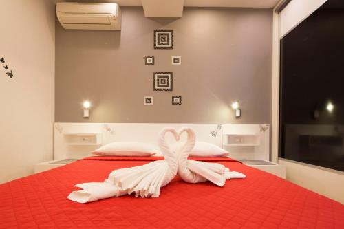 a bed with two white towels in the shape of a heart at Villa Nena in Makarska