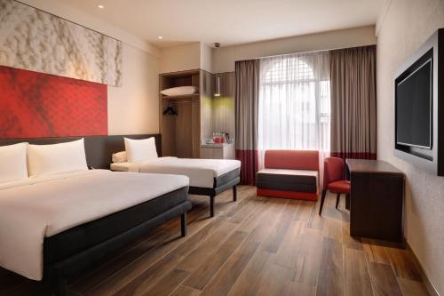 A bed or beds in a room at Ibis Melaka