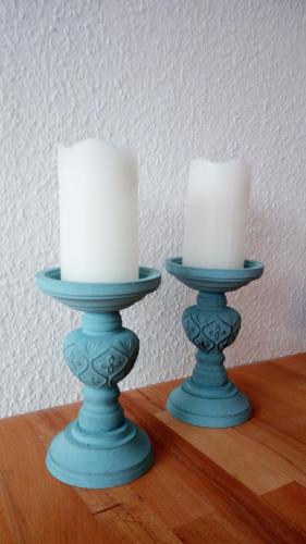 two candles sitting on top of a wooden table at Ferienwohnung mit Loggia in Münster