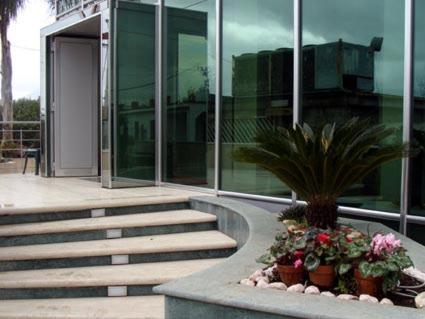 a building with stairs and flowers in front of it at Hotel Nappo in San Marzano sul Sarno