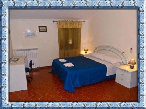 a bedroom with a bed with a blue bedspread at al castello in Tarquinia