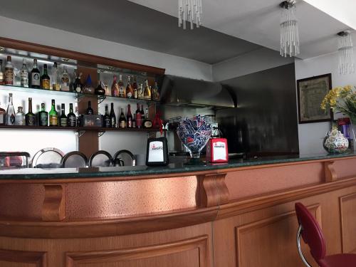 a bar with a lot of bottles of alcohol at Hotel Nappo in San Marzano sul Sarno