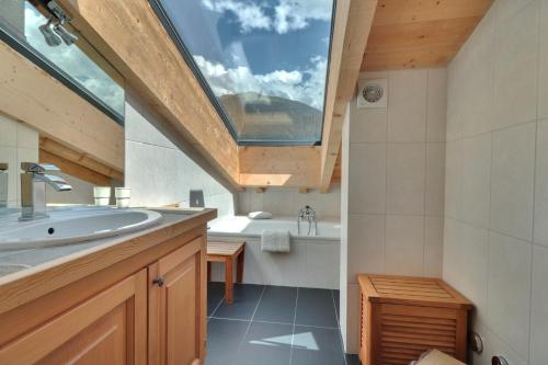 a bathroom with a sink and a large window at Olympia 443 in Verbier