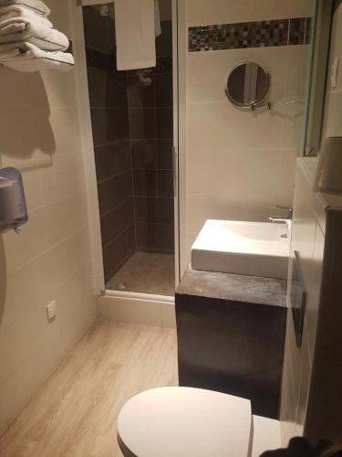 a bathroom with a toilet and a sink and a shower at Logis - Hôtel du Nord et Restaurant La Table d'Elisa in Compiègne