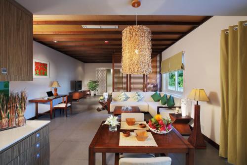 a living room with a couch and a table at The Cliff Resort & Residences in Mui Ne
