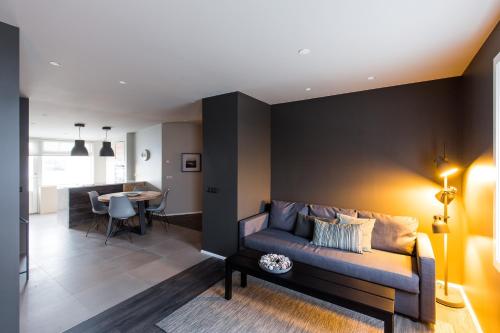 a living room with a couch and a table at Acco Luxury Apartments in Akureyri