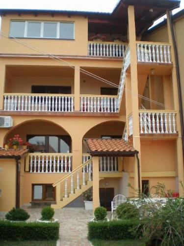 a large building with balconies and stairs on it at Apartment Zdravko in Štinjan
