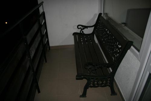 a black bench sitting in a hallway next to a staircase at Yellow House in Smolyan