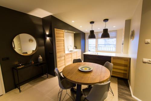 a kitchen and dining room with a table and chairs at Acco Luxury Apartments in Akureyri