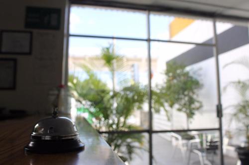 a bell sitting on a table in front of a window at Casa Zapopan Hotel in Guadalajara