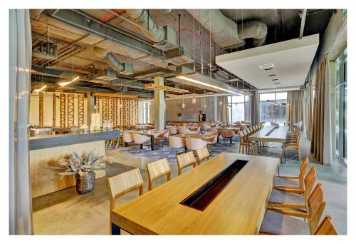 a restaurant with wooden tables and chairs in a room at Folwark Łochów in Łochów