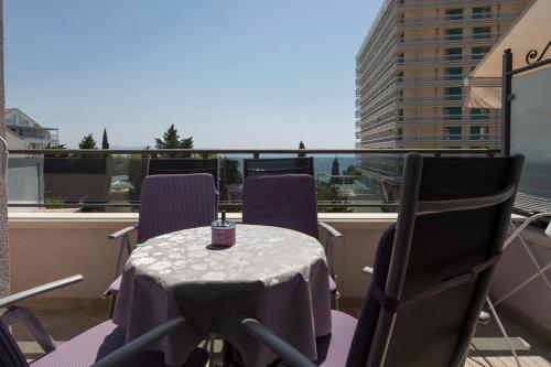 a table and chairs on a balcony with a view at Villa Nena in Makarska